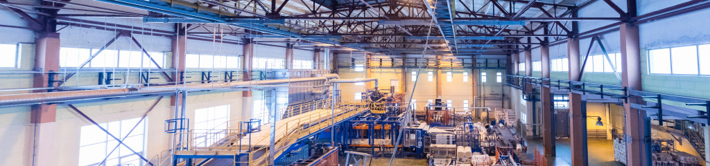Factory workshop interior and machines on glass production background