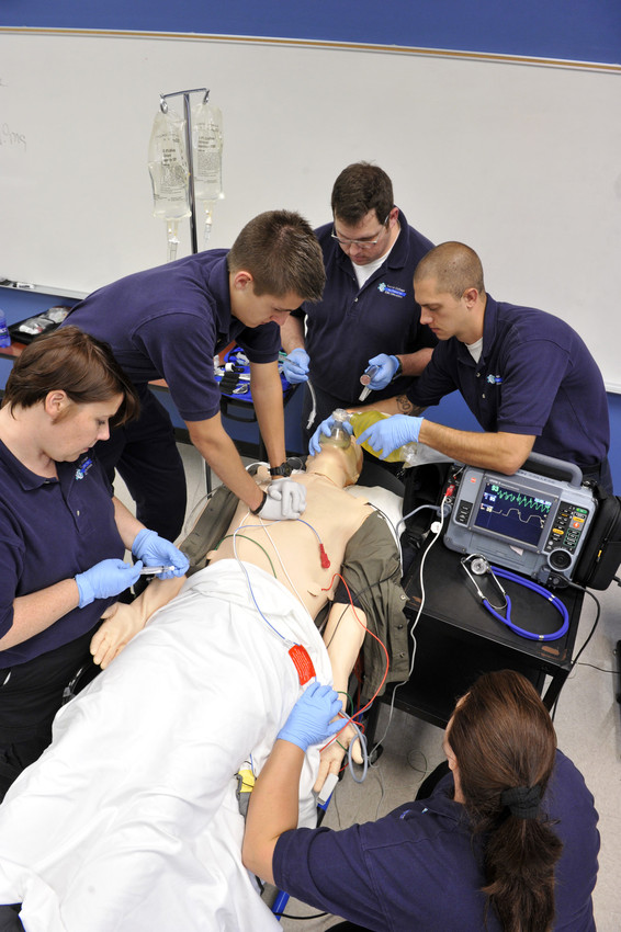 An image of EMS students practicing on a CPR dummie