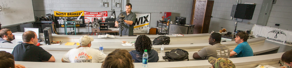 Automotive Instructor teaching in front of open classroom