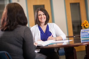 Friendly female staff helps advises student on career choices