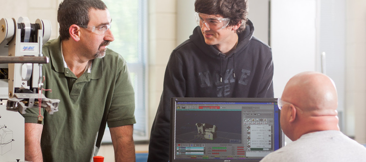 Three students discuss robotics together