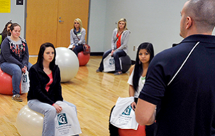 Students learn healthy exercise with yoga balls