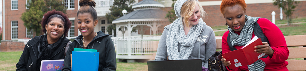 A picture of female students studying together outside on Dallas Campus