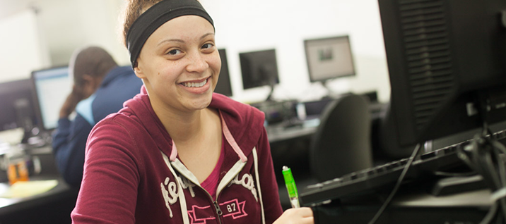Smiling female student in computer lab