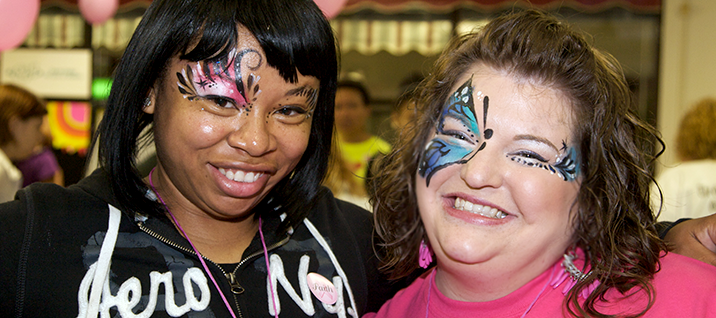 Two female students smiling with face paint