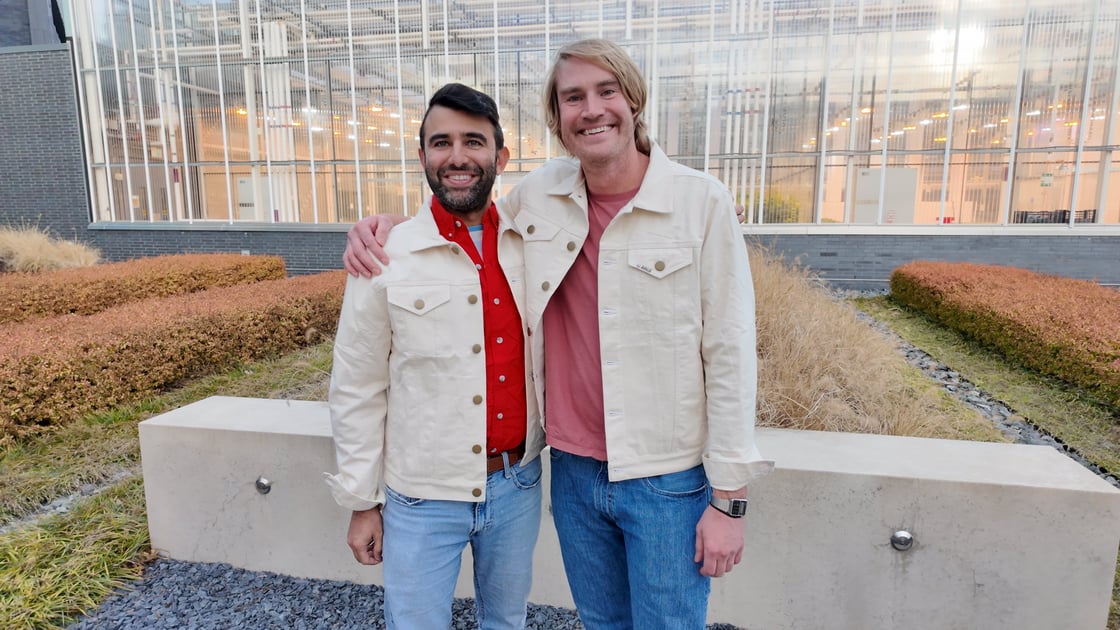 Two males smiling and wearing the Avalo Genesis Jackets that were created through a partnership with Gaston's Textile Technology Center.