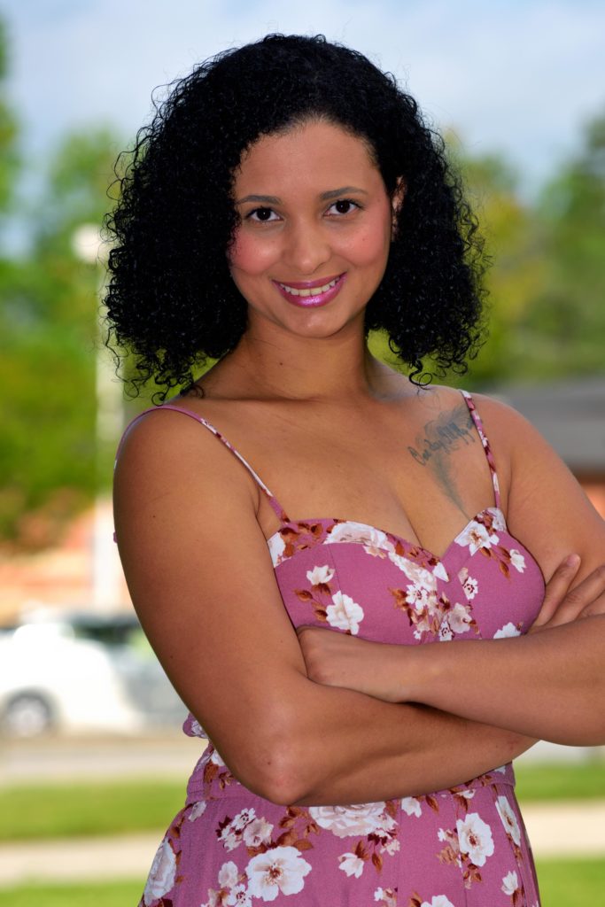 Female posing outside with arms crossed