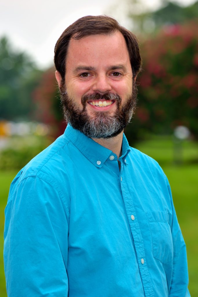 Male wearing blue shirt smiling