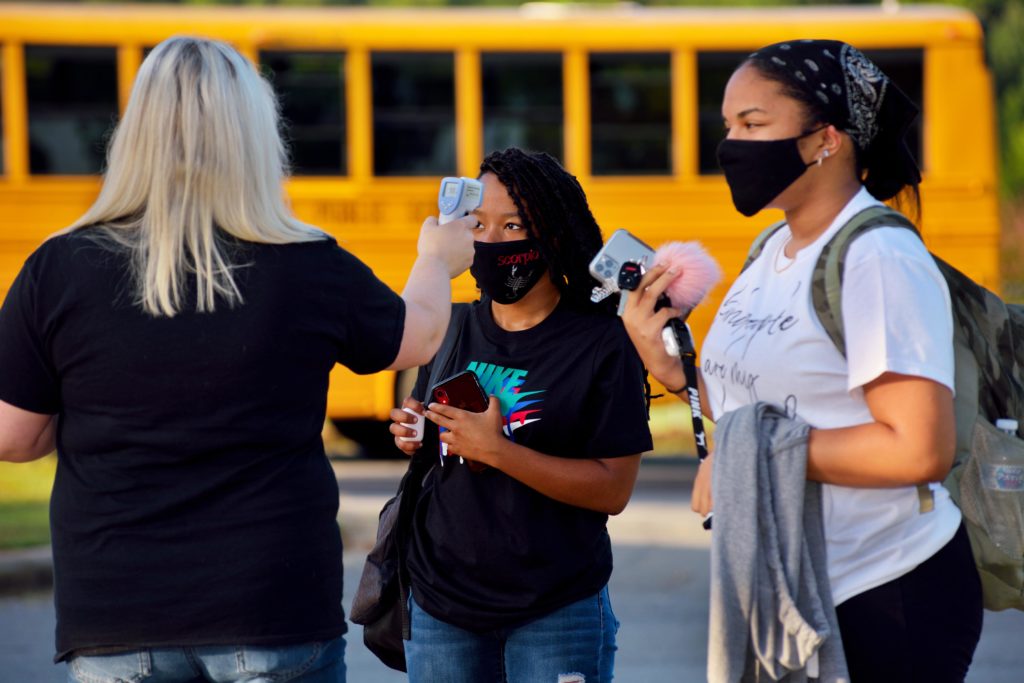 high school students receiving COVID-19 temperature checks