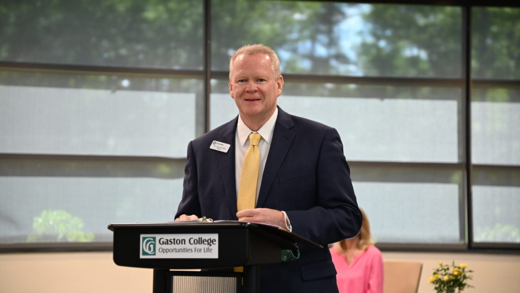 Dr. Hauser standing at a podium