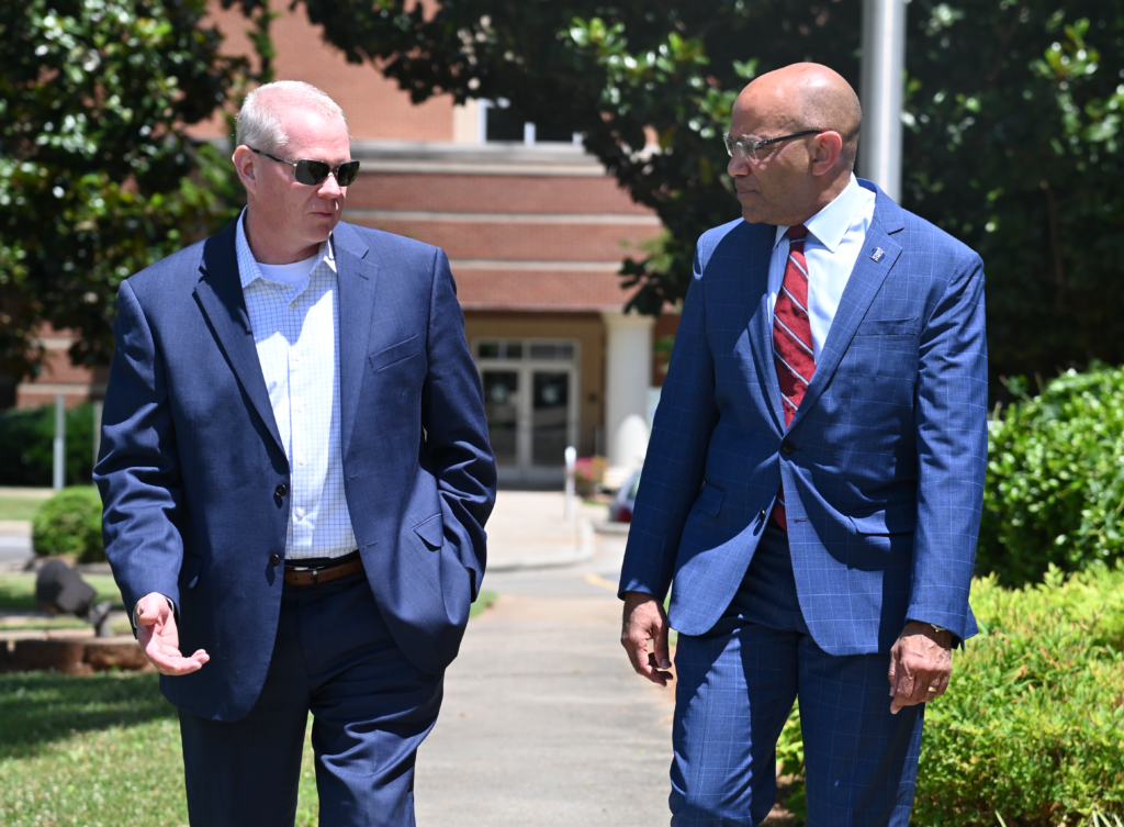 Dr. Hauser and NCCCS president Thomas Stith chat outside at Gaston College