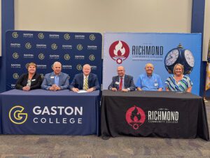 Representatives from Gaston College and Richmond Community College sign instructional services agreement for 911 Communications and Operations Program