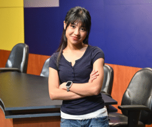 Outstanding Graduate of Audio & Video Production Technology Mikhaela Gene Abarientos with arms folded in conference room.